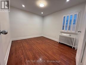 Toronto (Danforth Village-East York) apartment for rent - A room with wooden flooring and a window with blinds.