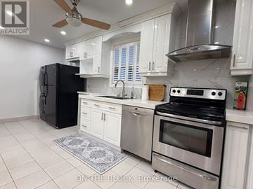 Toronto (Danforth Village-East York) apartment for rent - A modern kitchen with stainless steel appliances and white cabinets.