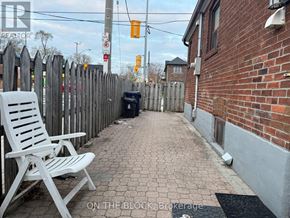 Toronto (Danforth Village-East York) apartment for rent - A white chair is on a brick walkway.