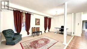 Richmond Hill (Westbrook) apartment for rent - A living room with a green armchair and a red patterned rug.