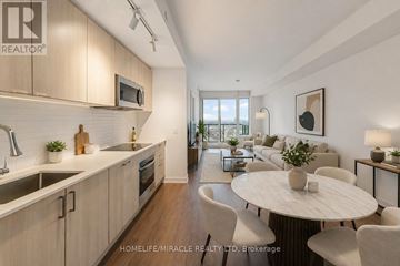 Toronto (South Parkdale) condo for rent - A modern kitchen with a dining table and chairs.