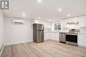 Ottawa multi-family for rent - A modern kitchen with stainless steel appliances and white cabinets.
