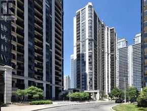 Toronto (Lansing-Westgate) condo for rent - A view of a city street with tall buildings and a clear blue sky.