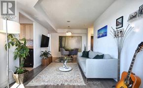 Toronto (Lansing-Westgate) condo for rent - A living room with a white couch, a glass coffee table, and a guitar leaning against the wall.
