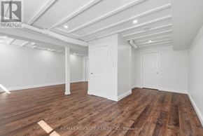Mississippi Mills townhouse for rent - A room with wooden flooring and white walls, with a door and a window.