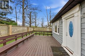 Fort Erie (Ridgeway) apartment for rent - A deck with a white door and a brown railing.