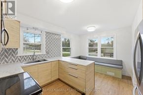 Fort Erie (Ridgeway) apartment for rent - A kitchen with wooden cabinets and a window seat.