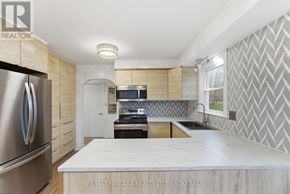 Fort Erie (Ridgeway) apartment for rent - A modern kitchen with a stainless steel refrigerator and a central island.