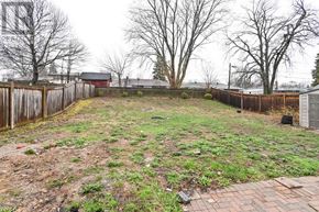 Oshawa (Centennial) apartment for rent - A backyard with a fence and a small shed.
