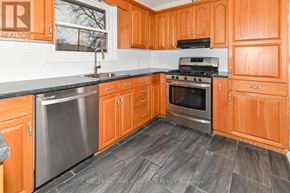 Oshawa (Centennial) apartment for rent - A kitchen with wooden cabinets and a stainless steel dishwasher.