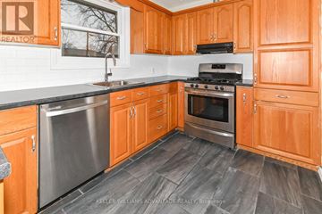 Oshawa (Centennial) apartment for rent - A kitchen with wooden cabinets and a stainless steel dishwasher.