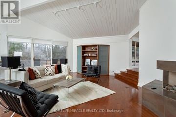 King (King City) apartment for rent - A living room with a black chair and a white couch.