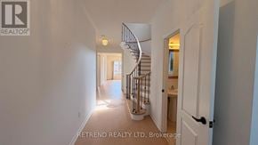 Vaughan (Patterson) apartment for rent - A hallway with a staircase and a door on the right side.