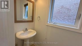 Vaughan (Patterson) apartment for rent - A bathroom with a sink, mirror, and window.
