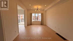 Vaughan (Patterson) apartment for rent - A spacious room with a large window and a chandelier.