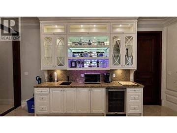 Richmond apartment for rent - A kitchen with white cabinets and a granite countertop.