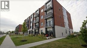 Ayr apartment for rent - A modern apartment building with balconies and a walkway in front.
