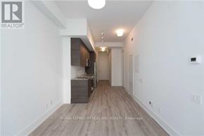 Toronto (Church-Yonge Corridor) condo for rent - A spacious room with a kitchen area and a dining table.