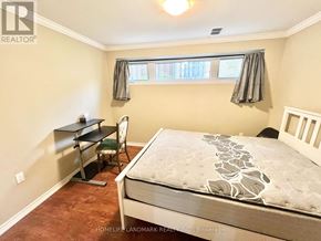 Toronto (Bathurst Manor) apartment for rent - A bedroom with a bed, desk, and chair.