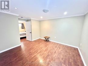 Toronto (Bathurst Manor) apartment for rent - A room with wooden flooring and a ceiling light fixture.