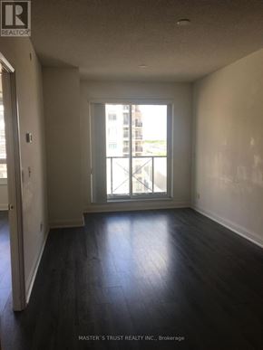 Markham (Unionville) condo for rent - A room with a window and wooden floors.