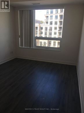 Markham (Unionville) condo for rent - A room with a window and wooden flooring.