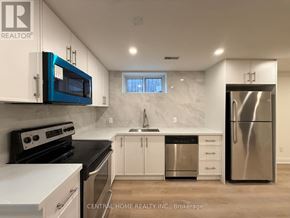 Markham (Bullock) apartment for rent - A kitchen with white cabinets and a blue microwave.