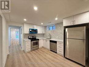 Markham (Bullock) apartment for rent - A modern kitchen with stainless steel appliances and white cabinets.