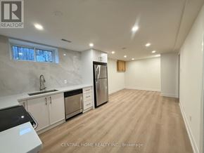 Markham (Bullock) apartment for rent - A kitchen with white cabinets and a black fridge.