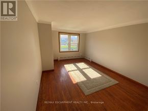 Port Colborne (Main Street) apartment for rent - A room with a window and wooden flooring.