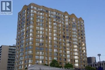 Windsor condo for rent - A tall building with many windows is shown in the image.
