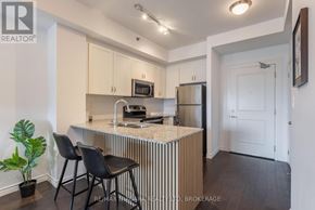 Burlington (Lasalle) condo for rent - A kitchen with a white countertop and black chairs.