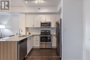 Burlington (Lasalle) condo for rent - A kitchen with white cabinets and stainless steel appliances.