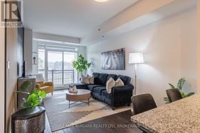 Burlington (Lasalle) condo for rent - A living room with a black couch and a coffee table.