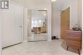 Ottawa condo for rent - A room with a white door, a mirror, a wooden cabinet, and a pair of shoes on the floor.