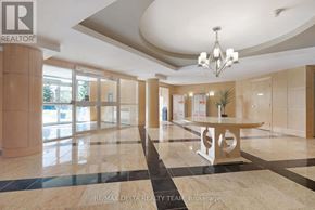Ottawa condo for rent - A spacious office lobby with a marble floor and a chandelier.