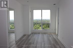 Toronto (Tam O'shanter-Sullivan) condo for rent - A room with a view of the cityscape through the windows.