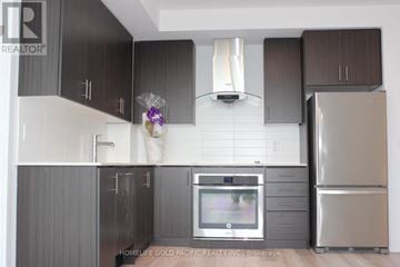 Toronto (Tam O'shanter-Sullivan) condo for rent - A modern kitchen with dark brown cabinets and stainless steel appliances.