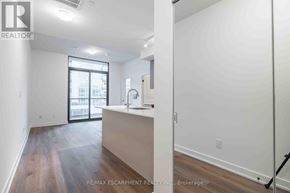 Burlington (Brant) condo for rent - A room with a large window and a wooden floor.