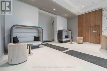 Burlington (Brant) condo for rent - A modern living room with a white sofa and a wooden door.