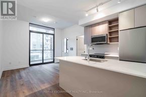 Burlington (Brant) condo for rent - A modern kitchen with a large island and a microwave above it.