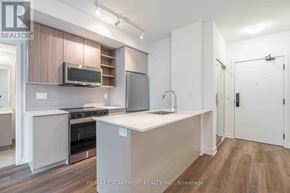 Burlington (Brant) condo for rent - A kitchen with a microwave, oven, and sink.