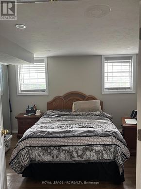 St. Catharines (Vine/Linwell) apartment for rent - A bedroom with a bed, nightstand, and window.