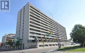 Oshawa (O'neill) condo for rent - A tall building with the words RE/MAX JAZZ IN on the side.