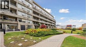 Oshawa (O'neill) condo for rent - A building with the sign REALTOR in the window of the first floor.