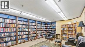 Oshawa (O'neill) condo for rent - A room filled with bookshelves and a rug on the floor.