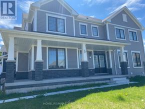 Brantford apartment for rent - A two-story house with a porch and multiple windows.