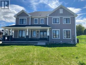 Brantford apartment for rent - A large house with a porch and multiple windows is for sale.