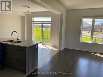 Brantford apartment for rent - A kitchen with a sink and a window overlooking a field.