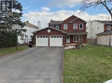 Ottawa apartment for rent - A house with a red brick exterior and a white garage door.